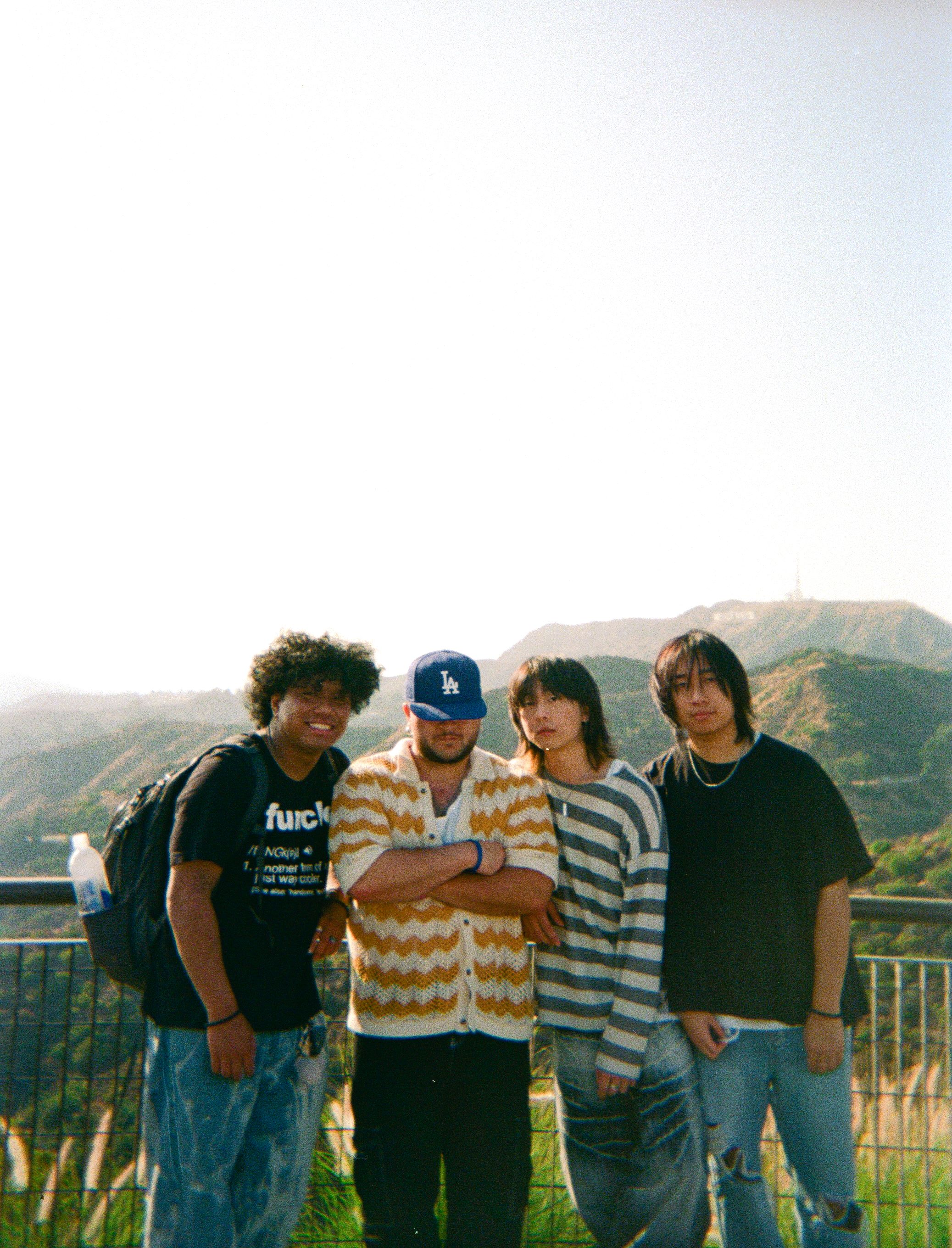 photo of 5 members on a beach near the water